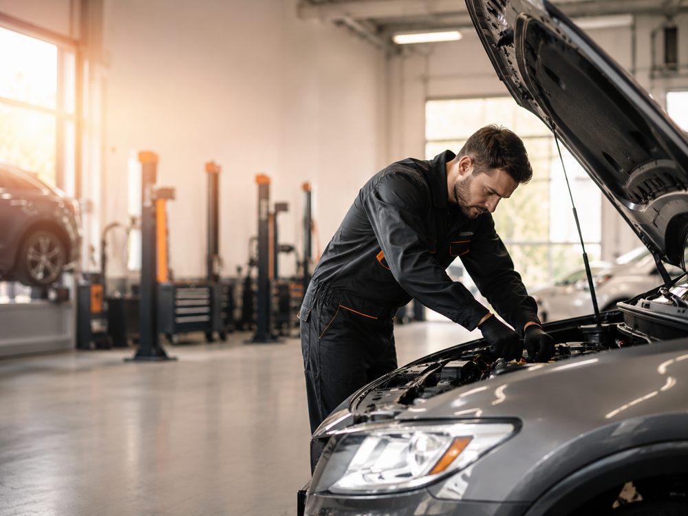 Automotive technician servicing a vehicle at Xzone Auto